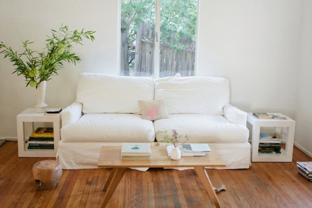 White sofa on warm wood flooring in a bright, simple living room